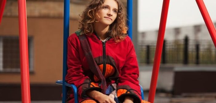 young woman sitting on swing
