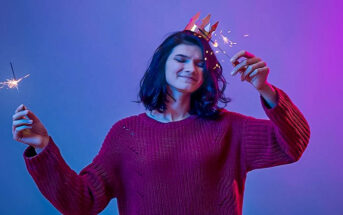 young woman with sparklers enjoying New Year's Eve alone