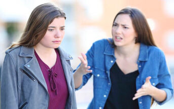 young woman being disrespectful to her friend in the street