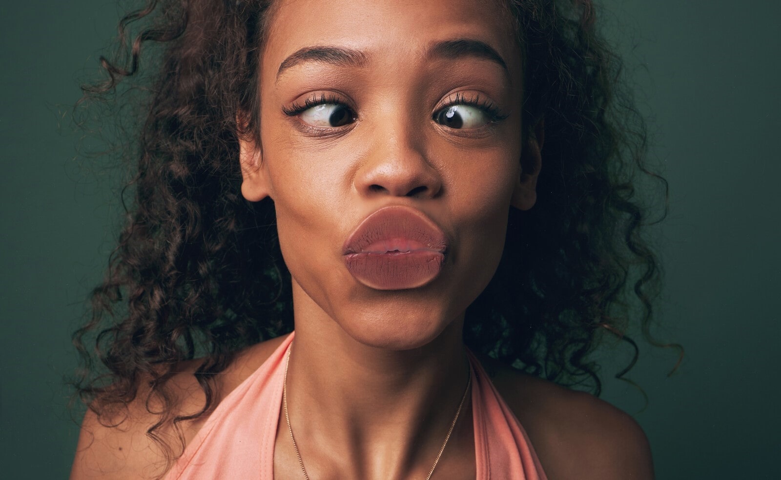 woman making funny face while kissing the camera lense