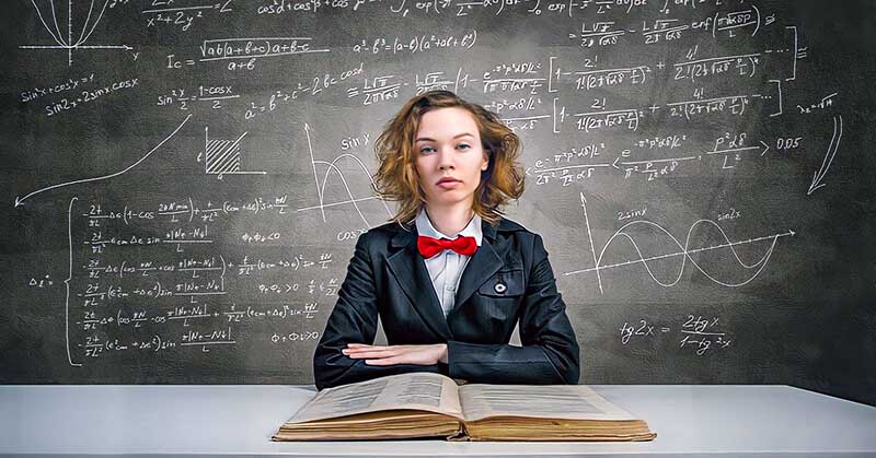 highly intelligent woman in front of chalkboard