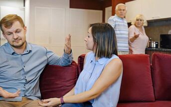 husband and wife arguing with his parents in background