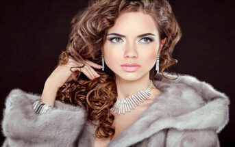woman in fur coat with expensive jewelry - illustrating a snob