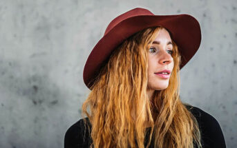 young woman with a red hat looking cool