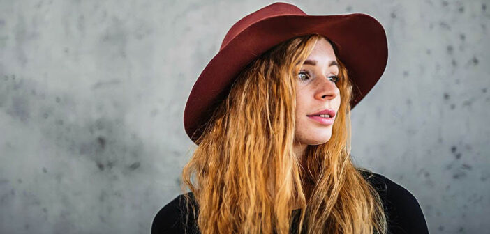 young woman with a red hat looking cool