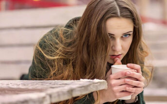 pensive woman holding a coffee to illustrate feeling like her life is going nowhere