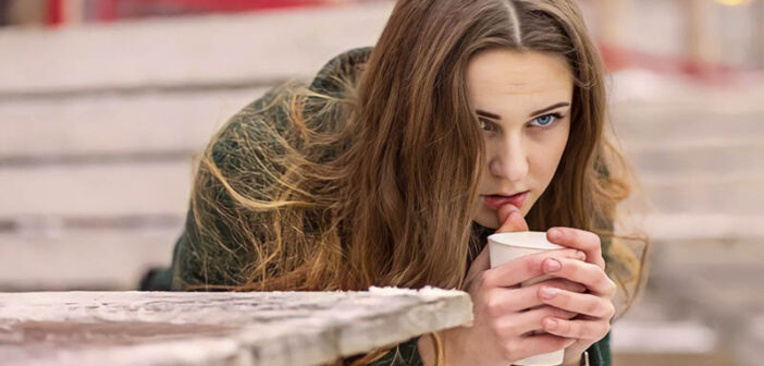 pensive woman holding a coffee to illustrate feeling like her life is going nowhere