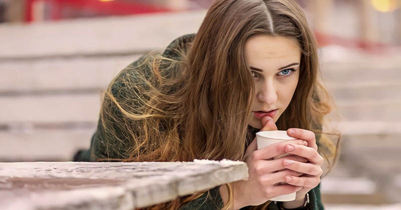 pensive woman holding a coffee to illustrate feeling like her life is going nowhere