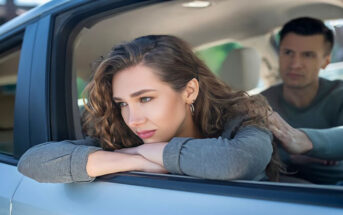 woman looking out of car window with boyfriend in the other seat - illustrating an on-again-off-again relationship