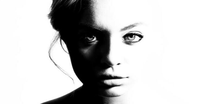 black and white photo of a young woman looking straight at the camera - how to be true to yourself