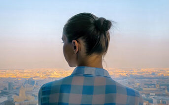 young woman looking out over city feeling like she has no direction in life