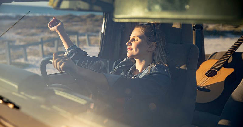 woman sitting in car enjoying sun - making every day count