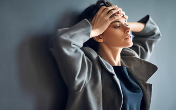 woman looking sad with hands on her forehead because she misses her boyfriend so much