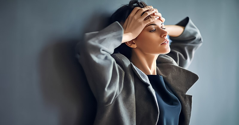 woman looking sad with hands on her forehead because she misses her boyfriend so much