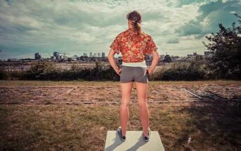 woman standing tall looking out over city - illustrating taking control of your life