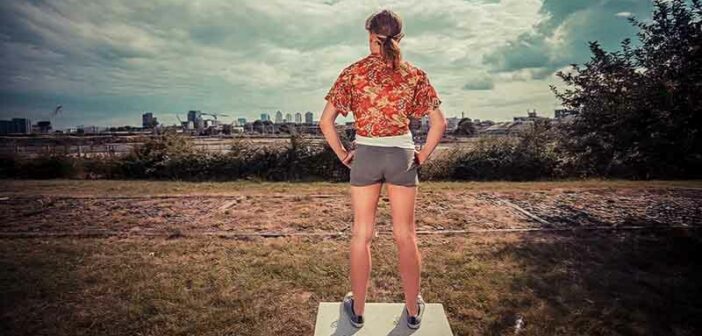 woman standing tall looking out over city - illustrating taking control of your life