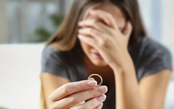 woman handing wedding ring back to her spouse after telling them she wants a divorce