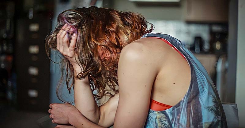 young woman looking distressed - illustrating being the family scapegoat