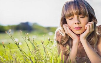 pensive woman on grass living in fear all the time