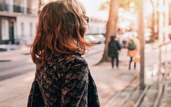 young woman walking on the street living without regret