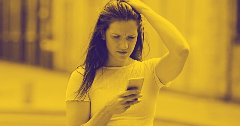 woman looking confused by text from her ex - why do men always come back?