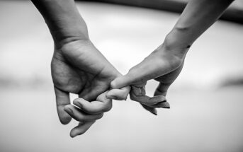 black and white photo of couple holding hands