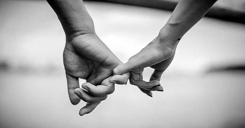 black and white photo of couple holding hands