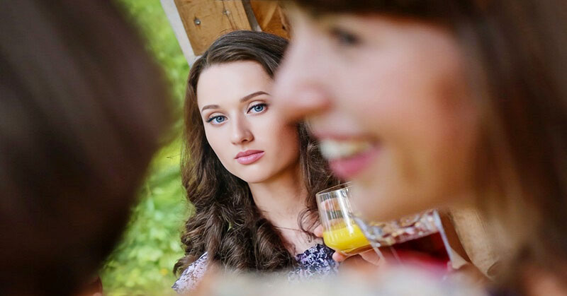 woman looking enviously at smiling person