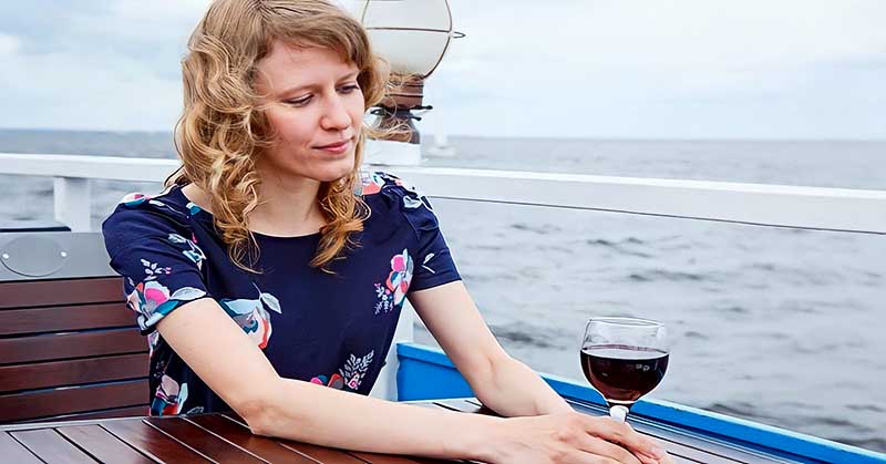 woman sitting alone on a boat feeling alienated by society