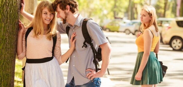 jealous woman looking at loving couple