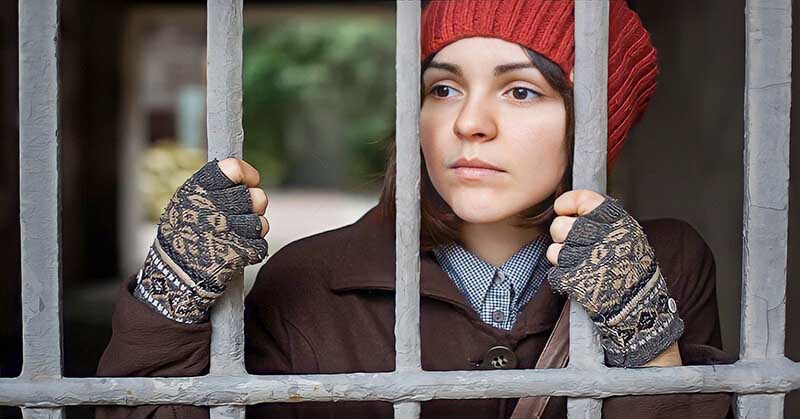 woman looking through bars - illustrating the no contact rule after a breakup with your ex