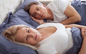 dissatisfied couple in bed who are no longer attracted to each other