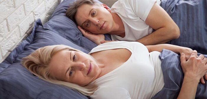 dissatisfied couple in bed who are no longer attracted to each other