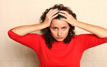 woman in red jumper with hands on head - illustrating not being a hypocrite