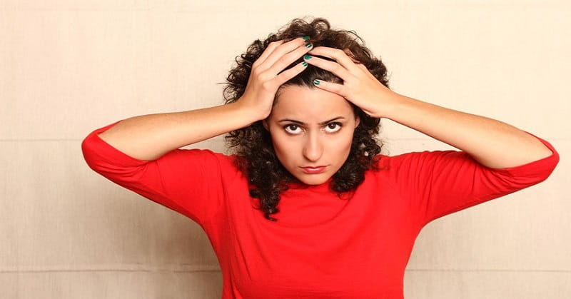 woman in red jumper with hands on head - illustrating not being a hypocrite