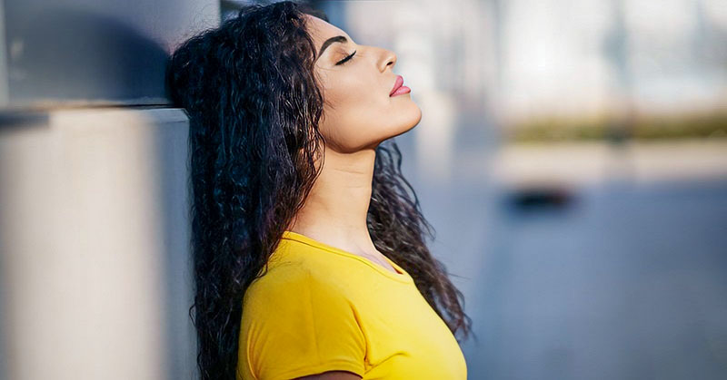 woman with her eyes closed who can't stop thinking about something