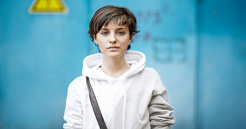 young woman in white hoodie with a fed up look on her face