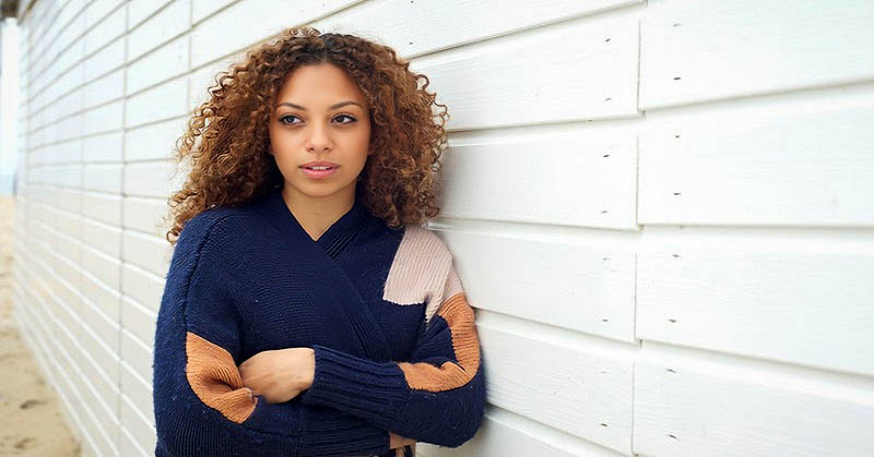 woman leaning against fence