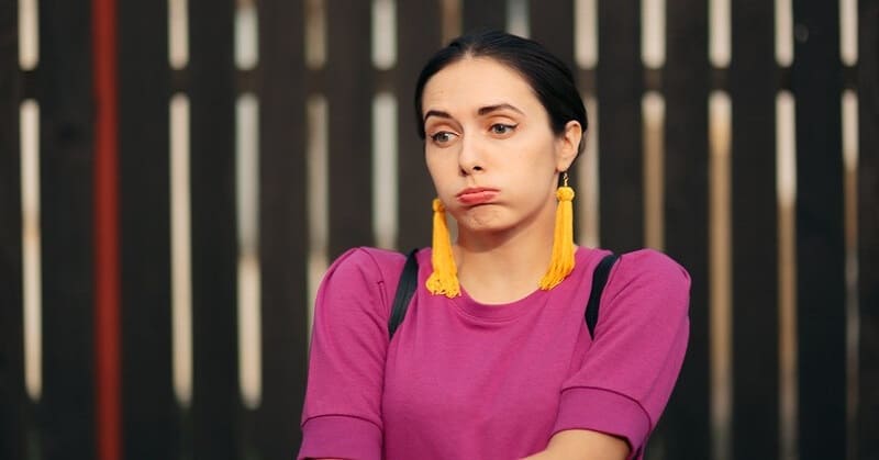 young woman looking very bored, needing a cure for her boredom