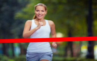 young woman running toward finish line - illustrating finishing what you started