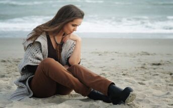 worried young woman sitting on a beach wondering how to fix her life