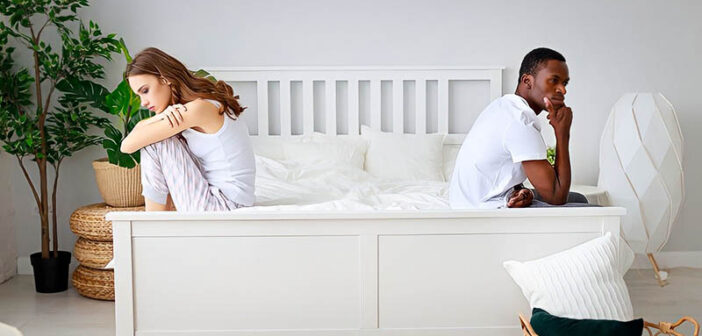 couple on bed not talking with neither of them feeling heard