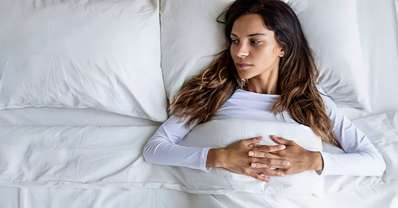woman in bed looking at empty space next to her because she's too picky in relationships