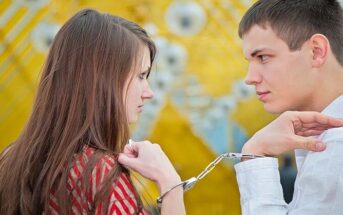 man and woman handcuffed together illustrating possessiveness in a relationship