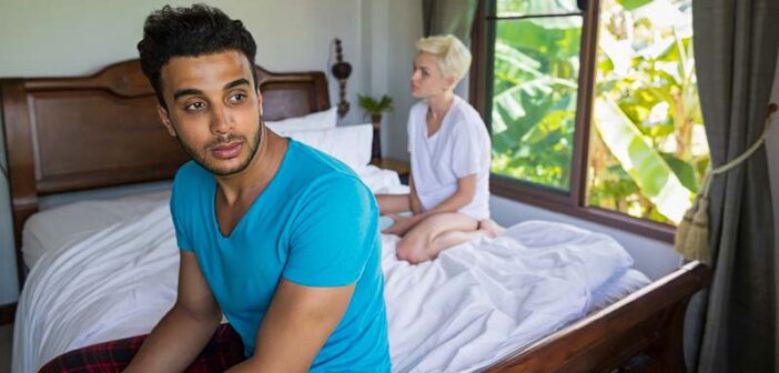 couple looking distant whilst sitting in bed illustrating not liking physical touch