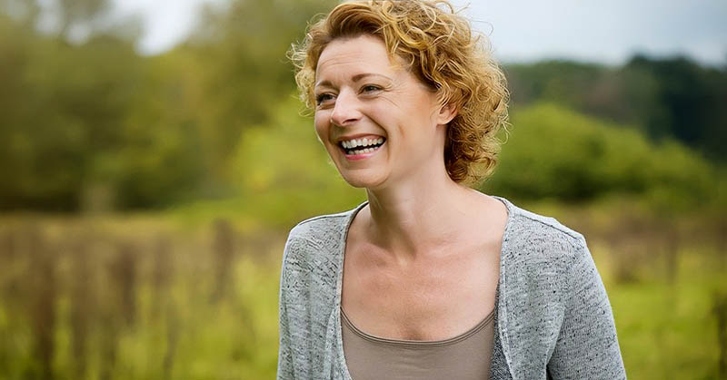 smiling middle-aged woman depicting inner beauty vs outer beauty