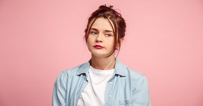 young woman looking disheartened because no one takes her seriously