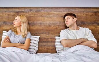 couple sitting in bed with arms crossed - illustrating a relationship with no trust