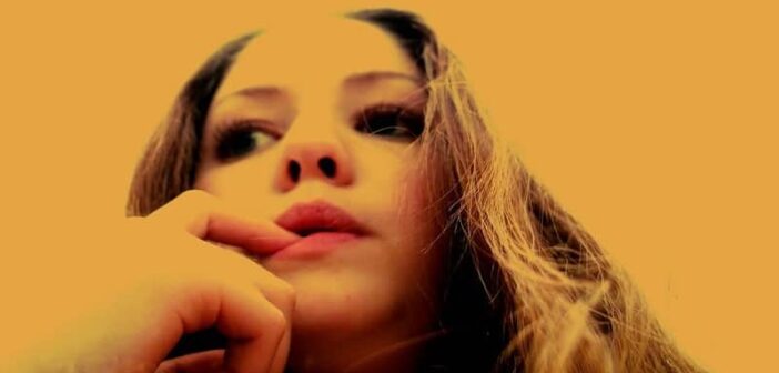 closeup of woman biting her fingernail second guessing a decision she has made