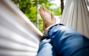 view of a person's legs and feet in a hammock - illustrating how to relax